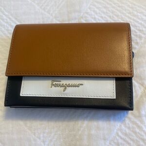 Brand new Ferragamo wallet black, white, tan. Room for coins, cards, bills